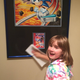 Dan’s daughter dusts off one of the pieces in his collection; the original art from Sonic Spinball for Sega Genesis. Photo courtesy ‘Bronty’
